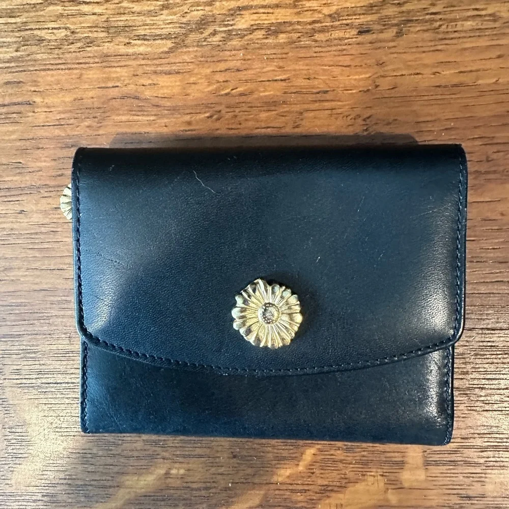 Black leather wallet with a red interior.